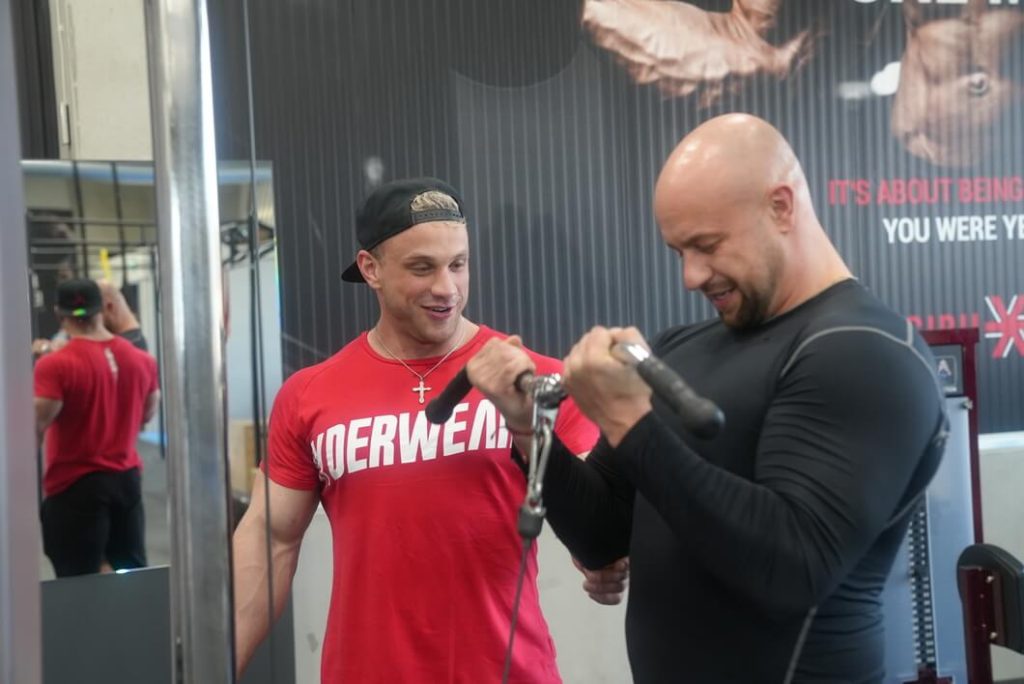 fitness trenér cvičící s klientem biceps